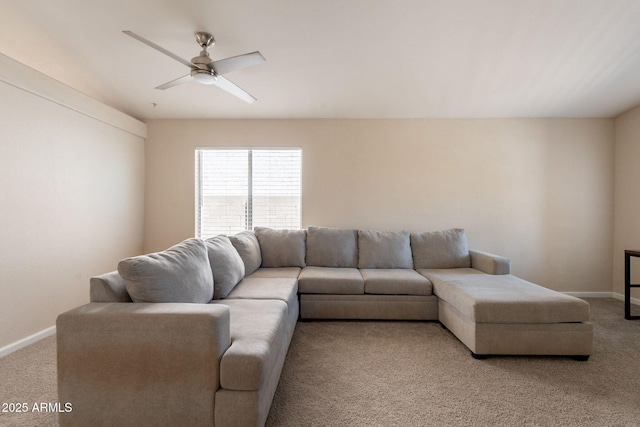 living area with light carpet, ceiling fan, and baseboards