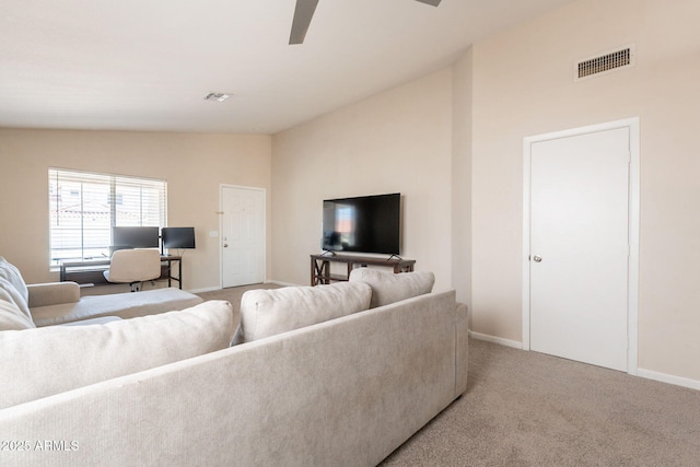 carpeted living area with lofted ceiling, a ceiling fan, and baseboards