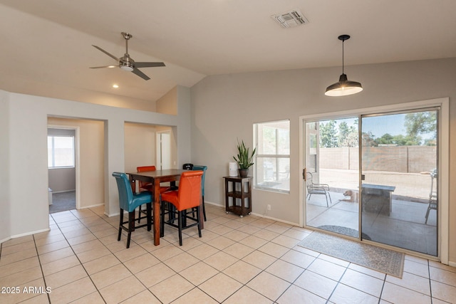 dining area featuring lofted ceiling, a ceiling fan, light tile patterned floors, and baseboards