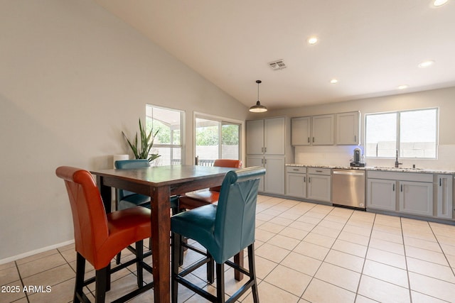 kitchen featuring stainless steel dishwasher, gray cabinets, a sink, light tile patterned flooring, and recessed lighting
