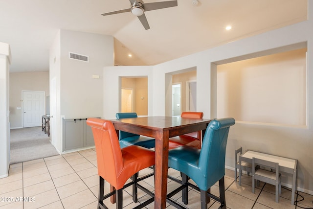 dining area with a ceiling fan, light tile patterned flooring, baseboards, and vaulted ceiling