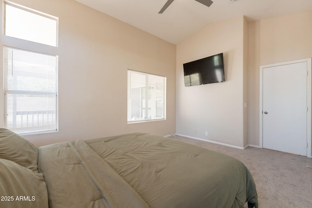 carpeted bedroom with lofted ceiling, baseboards, and ceiling fan