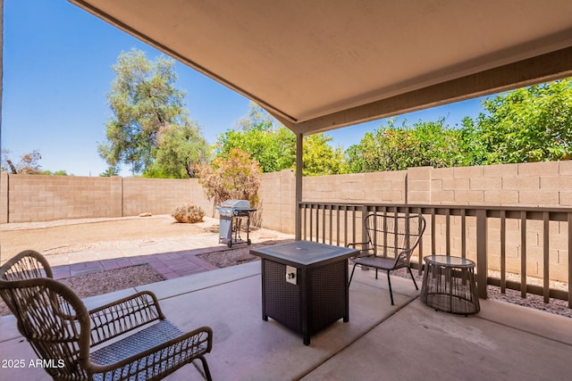 view of patio with a fenced backyard and grilling area
