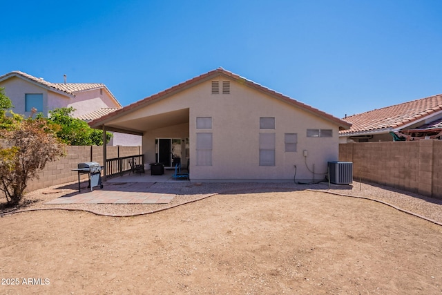 rear view of property featuring a patio, a fenced backyard, stucco siding, and central AC