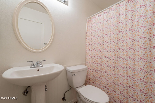 bathroom featuring toilet and a sink