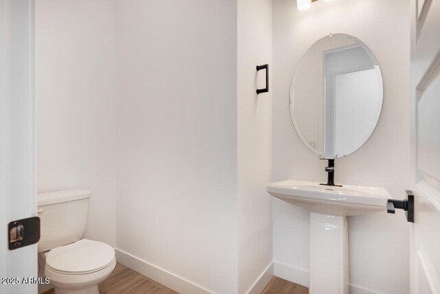 16994 W Canterbury Dr, Surprise, AZ 85388 - bathroom featuring wood finished floors, baseboards, and toilet