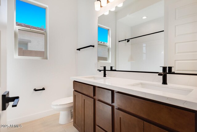 16994 W Canterbury Dr, Surprise, AZ 85388 - full bath featuring toilet, baseboards, double vanity, tile patterned floors, and a shower