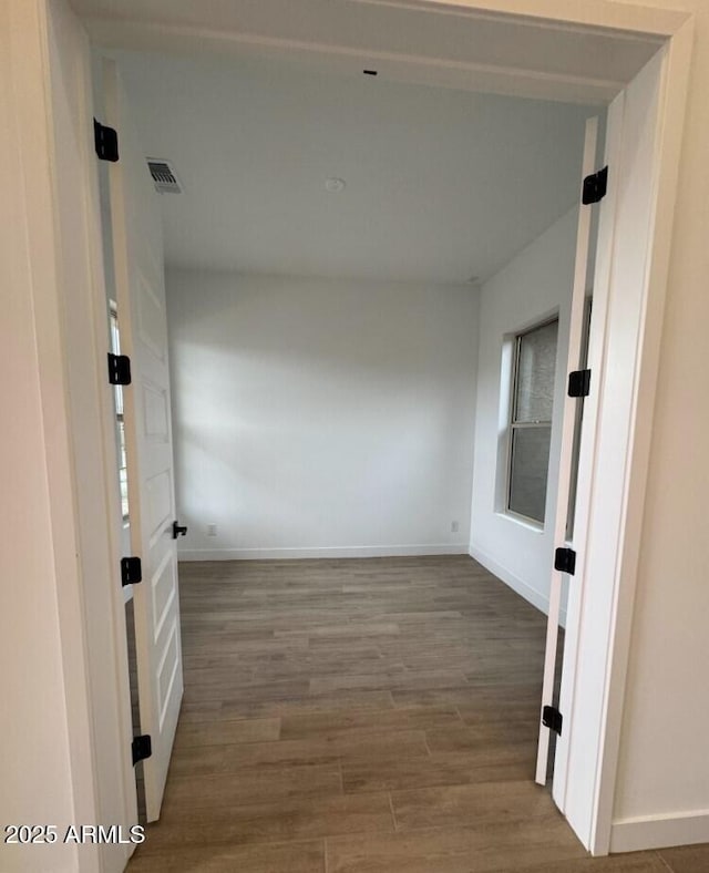 16994 W Canterbury Dr, Surprise, AZ 85388 - corridor with wood finished floors and baseboards