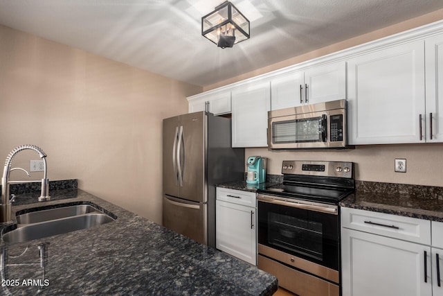 kitchen featuring white cabinetry, sink, and appliances with stainless steel finishes