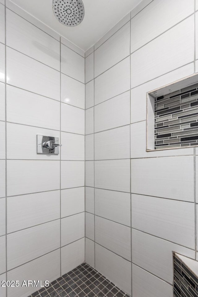 bathroom with tiled shower