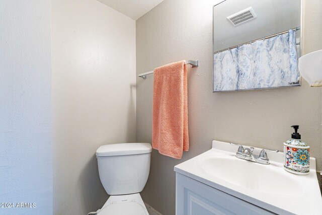 bathroom featuring vanity and toilet