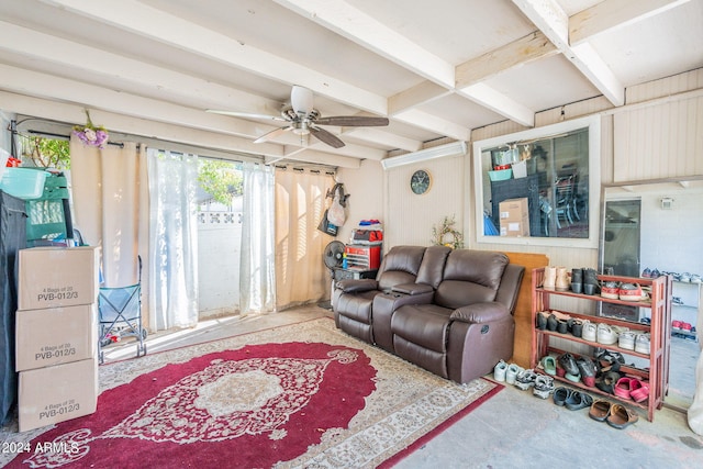 living room featuring ceiling fan and concrete flooring