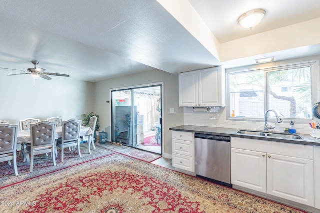 kitchen with ceiling fan, sink, tasteful backsplash, white cabinetry, and dishwasher