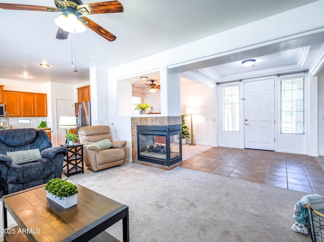 19403 E Arrowhead Trl, Queen Creek, AZ 85142 - carpeted living room featuring ceiling fan, tile patterned flooring, a tile fireplace, and baseboards