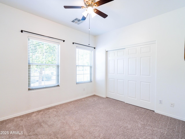 19403 E Arrowhead Trl, Queen Creek, AZ 85142 - unfurnished bedroom with carpet, a closet, baseboards, and ceiling fan