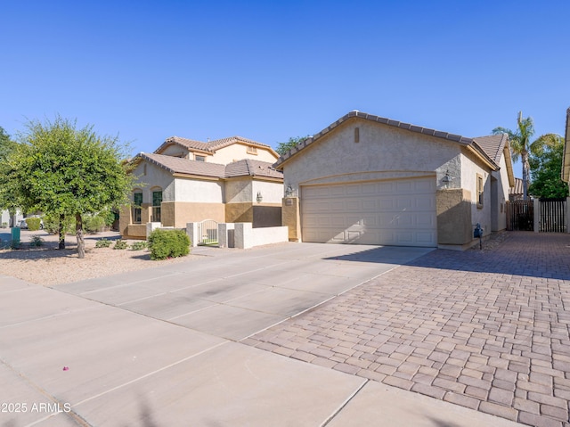 19403 E Arrowhead Trl, Queen Creek, AZ 85142 - view of front facade with concrete driveway, stucco siding, a gate, and a garage