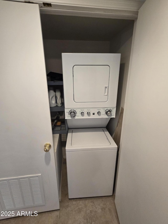 laundry room with stacked washer / drying machine