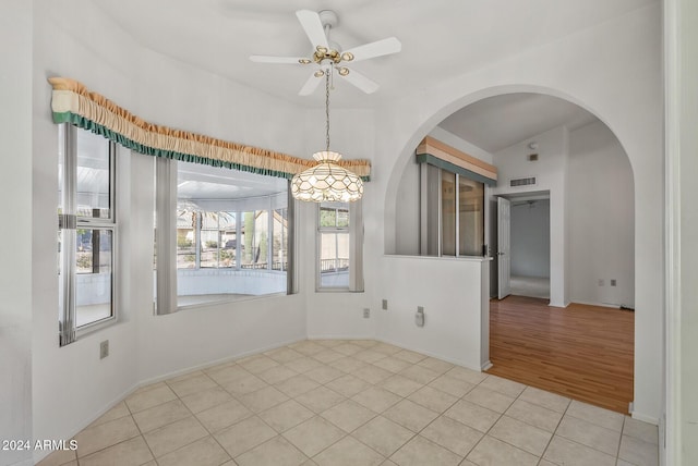 tiled empty room with ceiling fan