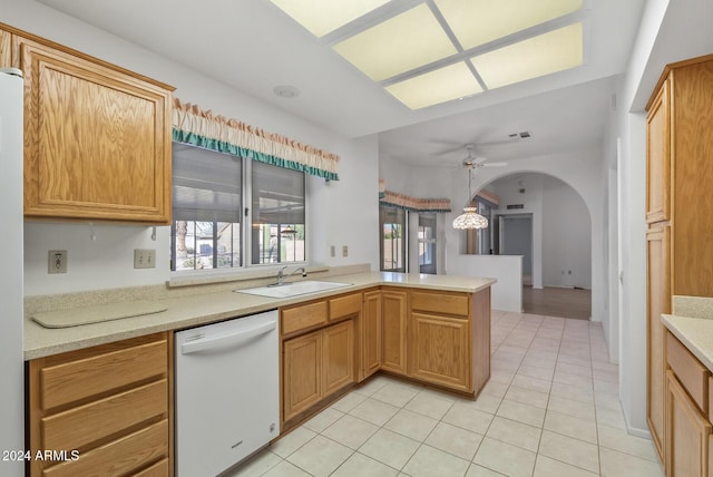 kitchen with ceiling fan, dishwasher, sink, kitchen peninsula, and light tile patterned floors