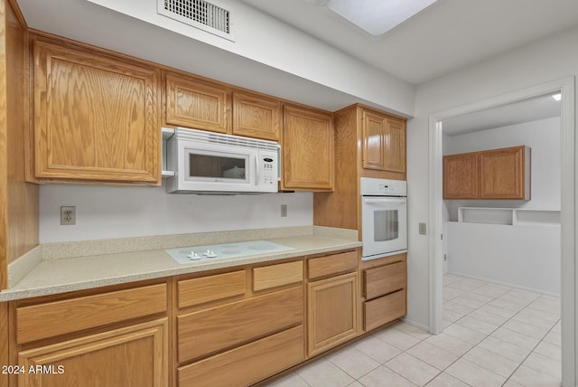 kitchen featuring white appliances and light tile patterned floors