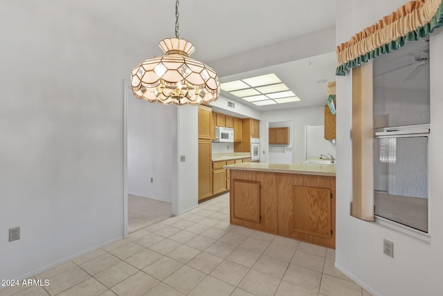 kitchen with ceiling fan, sink, hanging light fixtures, white appliances, and light tile patterned floors