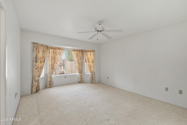 carpeted empty room with ceiling fan