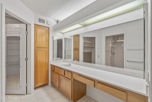 bathroom with tile patterned flooring, vanity, and an enclosed shower