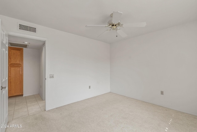 carpeted spare room with ceiling fan