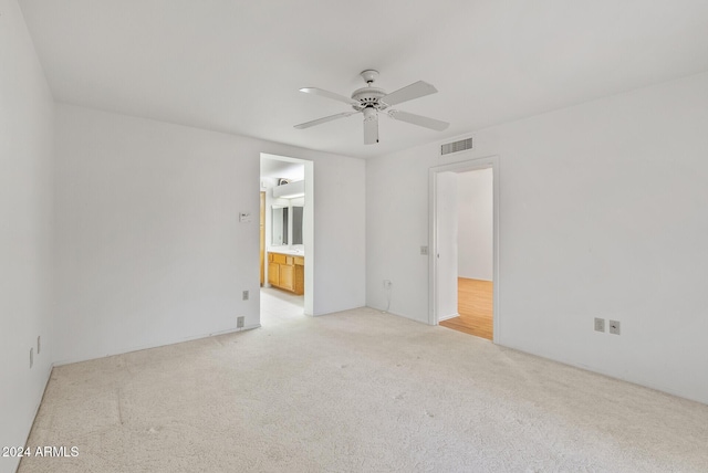 empty room featuring light colored carpet and ceiling fan