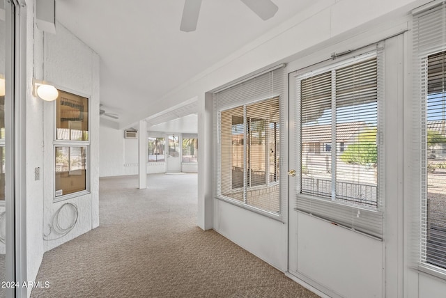 unfurnished sunroom with ceiling fan