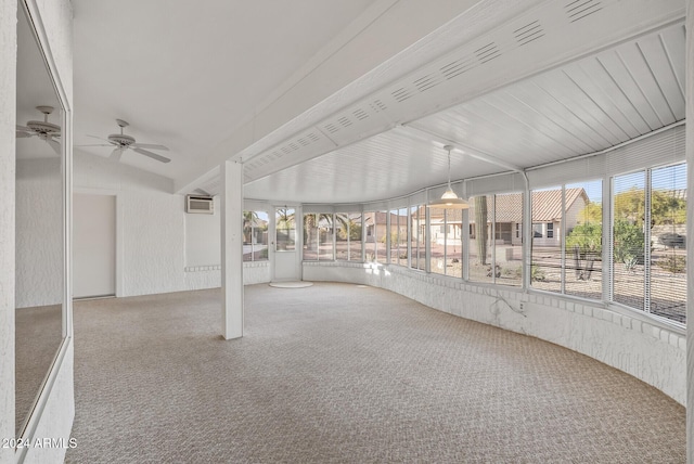 unfurnished sunroom with a wall mounted AC, vaulted ceiling, and ceiling fan