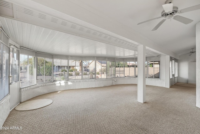 unfurnished sunroom with ceiling fan and a wealth of natural light