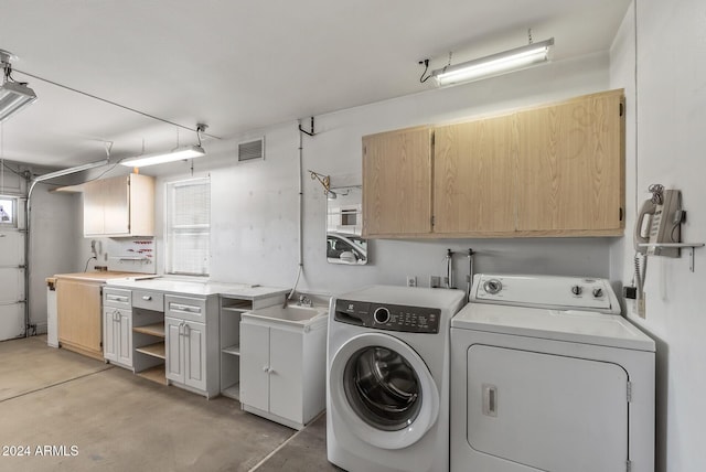 laundry area featuring sink and washer and dryer