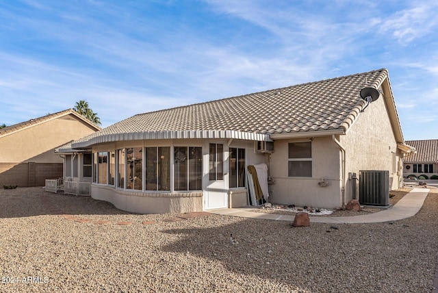 back of property featuring a sunroom and central air condition unit