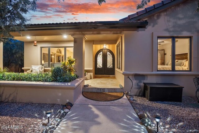 exterior entry at dusk with french doors