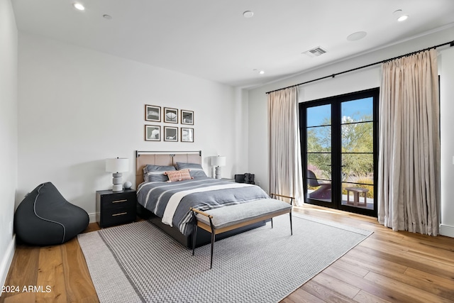 bedroom featuring access to exterior and light hardwood / wood-style floors