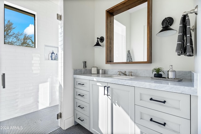 bathroom featuring vanity, tile patterned floors, and a shower with shower door