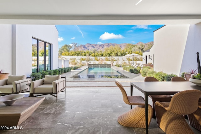 balcony with a mountain view, a patio area, and an outdoor hangout area