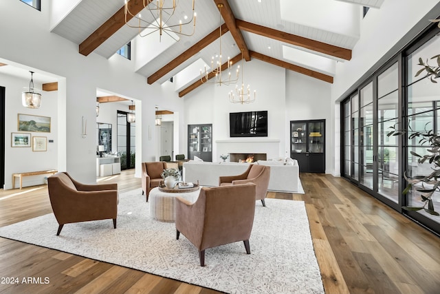 living room with hardwood / wood-style flooring, beamed ceiling, high vaulted ceiling, and an inviting chandelier