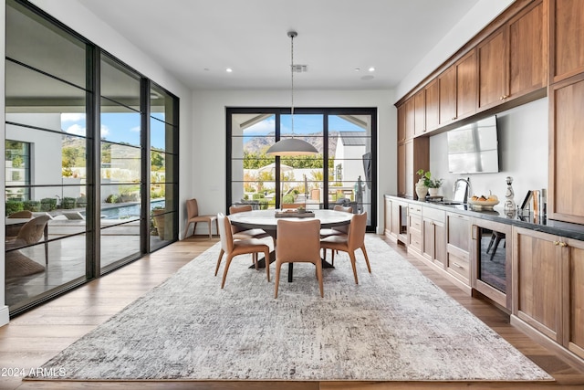 dining space featuring light hardwood / wood-style flooring and sink