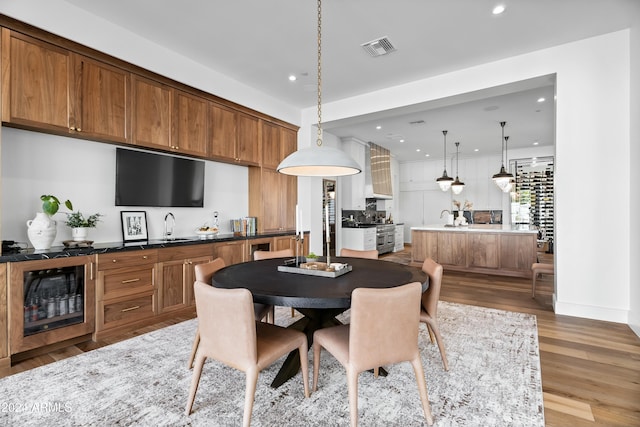 dining room featuring hardwood / wood-style floors and sink