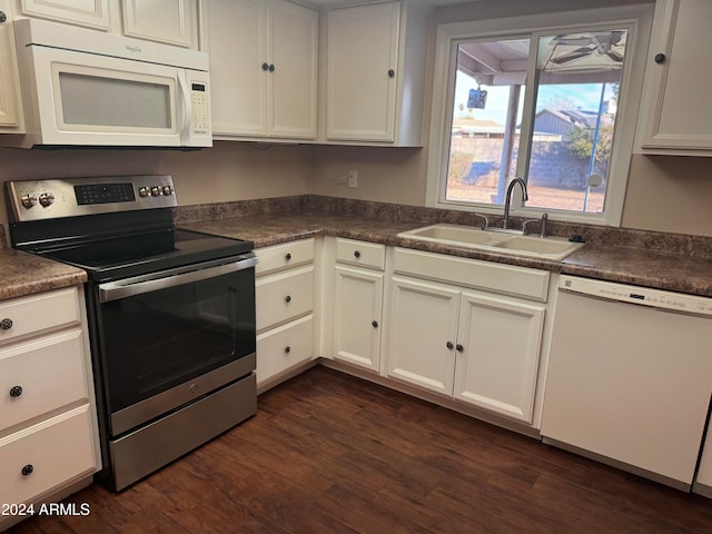 kitchen with sink, white cabinets, dark wood-type flooring, and white appliances