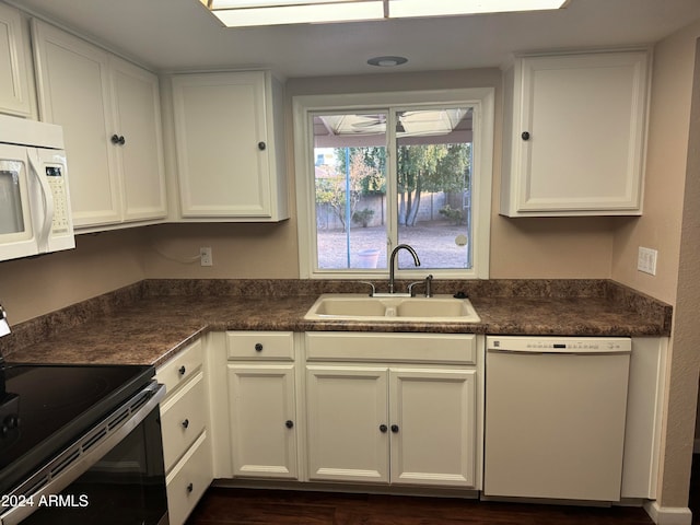 kitchen featuring white cabinets, white appliances, and sink