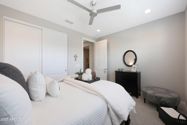 bedroom with recessed lighting, light carpet, a ceiling fan, visible vents, and a closet