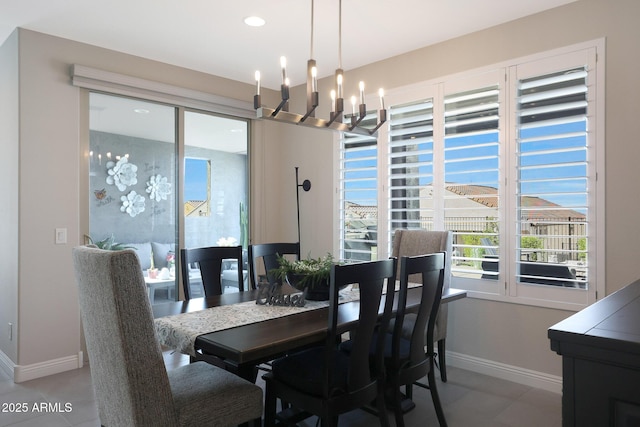 dining area with baseboards, a notable chandelier, and recessed lighting