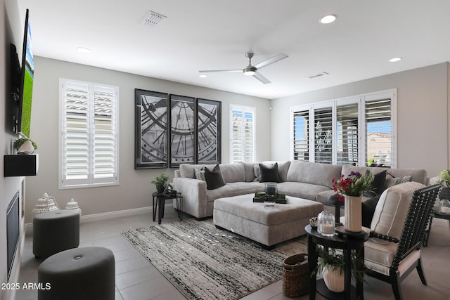 living area featuring a healthy amount of sunlight, visible vents, and recessed lighting