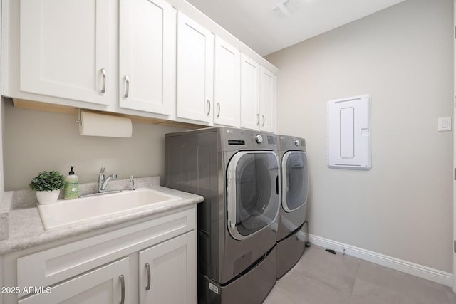 washroom featuring a sink, visible vents, baseboards, cabinet space, and washing machine and clothes dryer