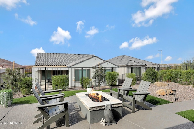 view of patio with a fire pit and fence