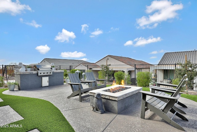 view of patio / terrace featuring grilling area, area for grilling, fence, a residential view, and a fire pit