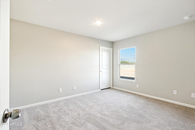 unfurnished room with light carpet